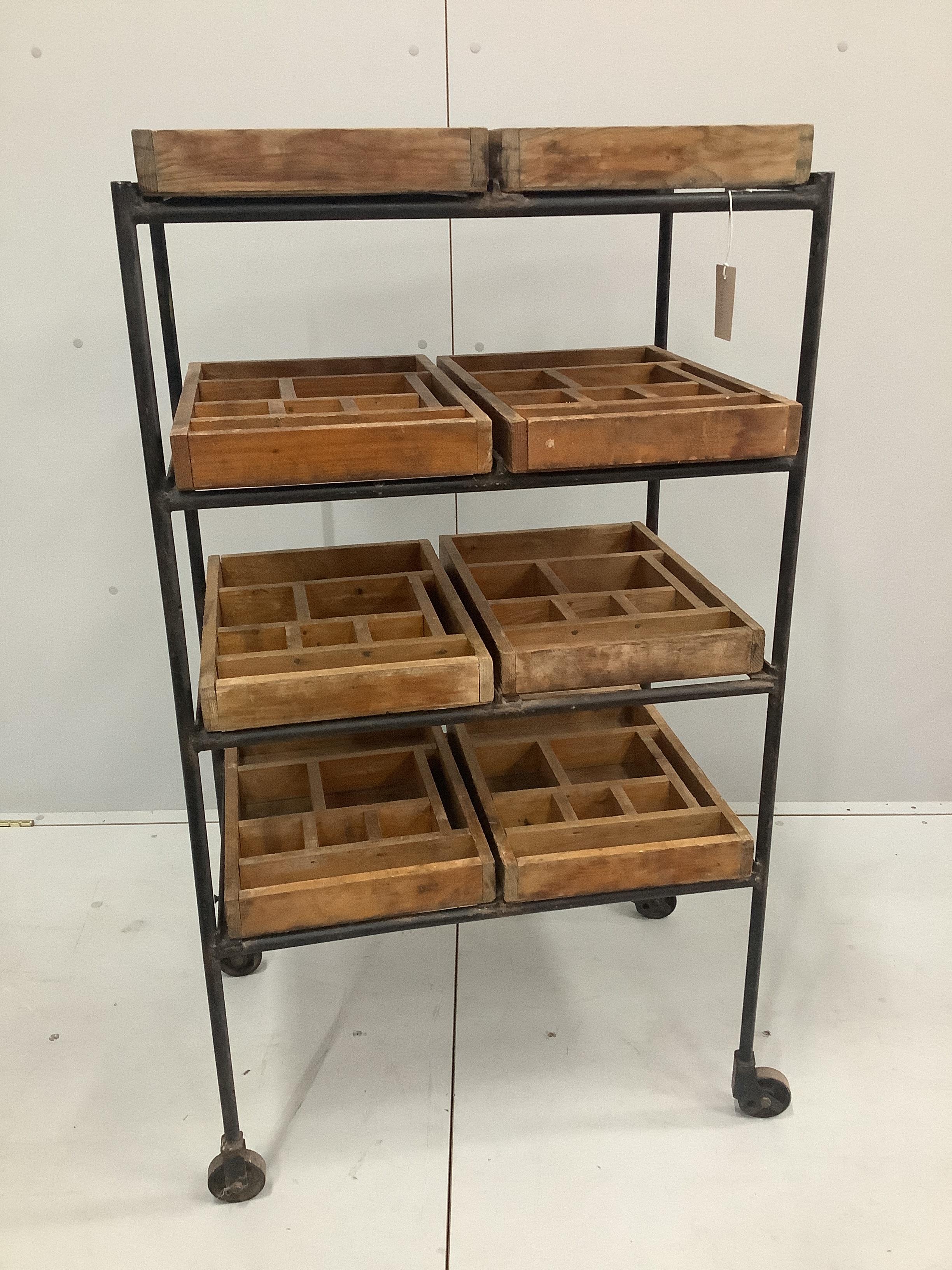 A wrought iron and pine four tier industrial trolley with eight printer's block trays, width 67cm, depth 46cm, height 120cm